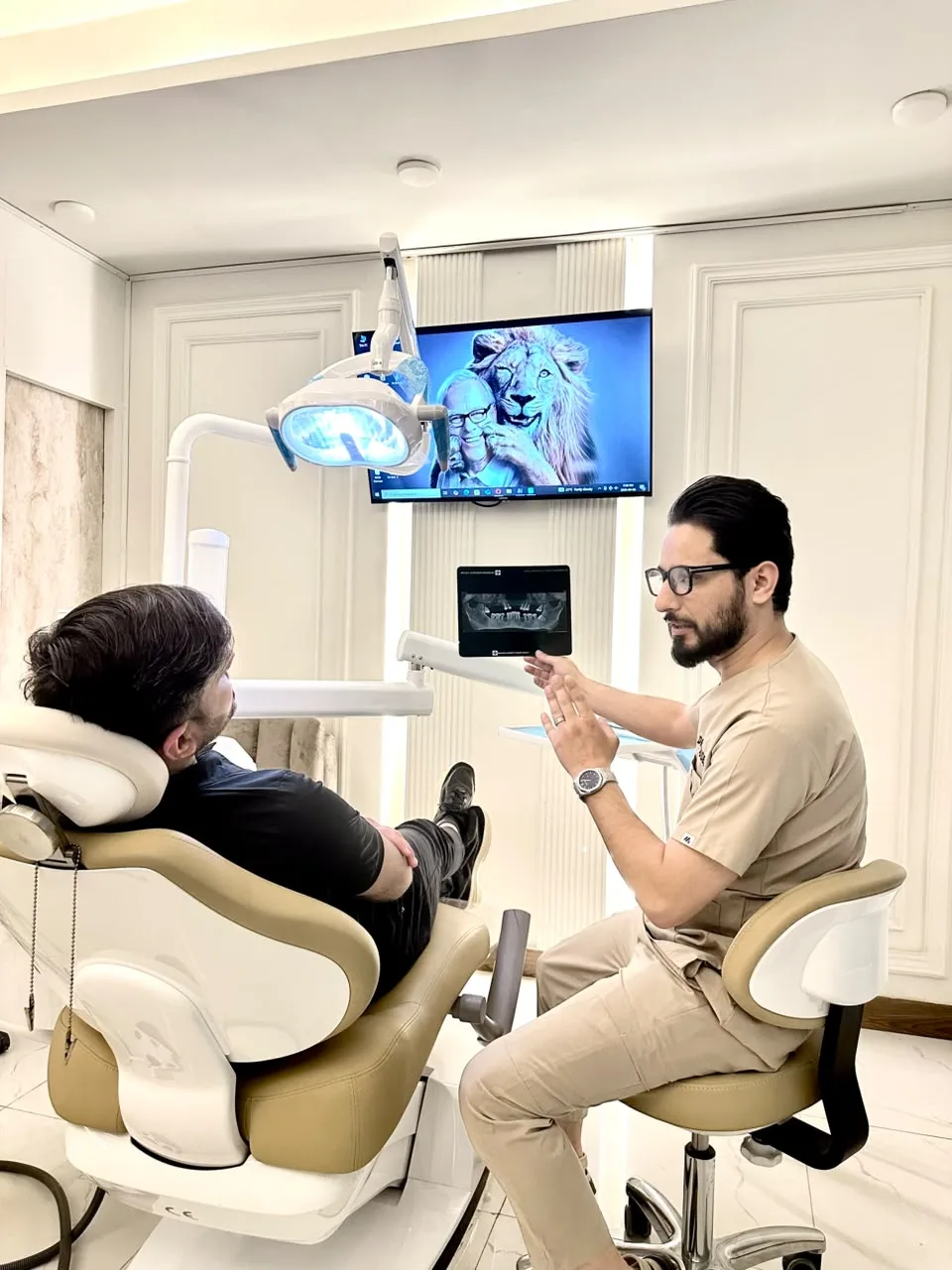 Dentist reviewing an X-ray with a patient in the treatment room